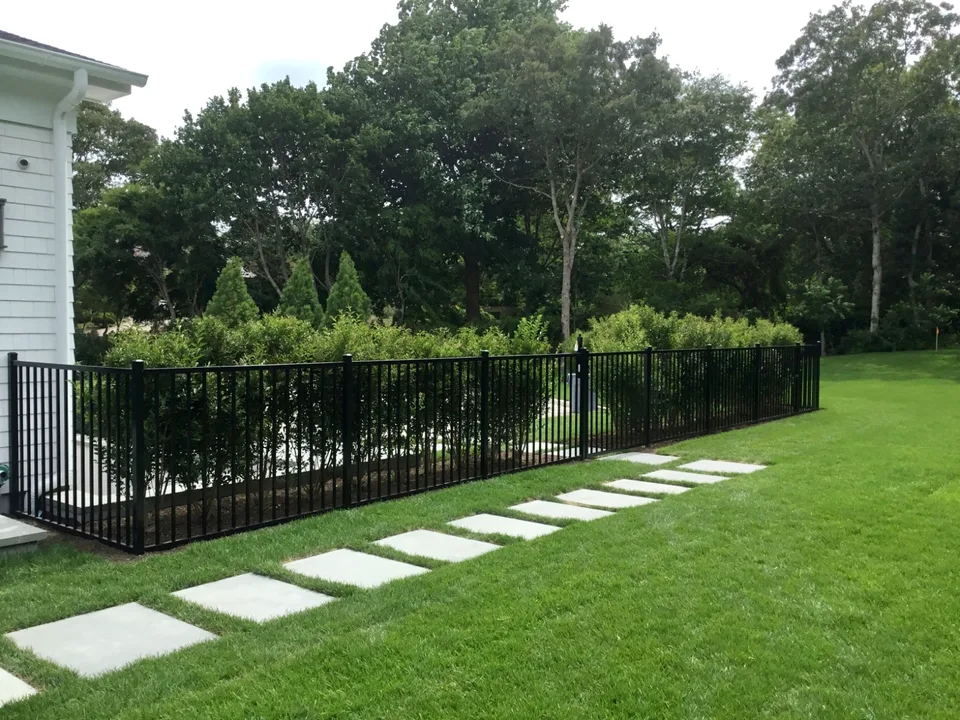 Long run of four-foot black aluminum residential fencing in Southampton, New York.