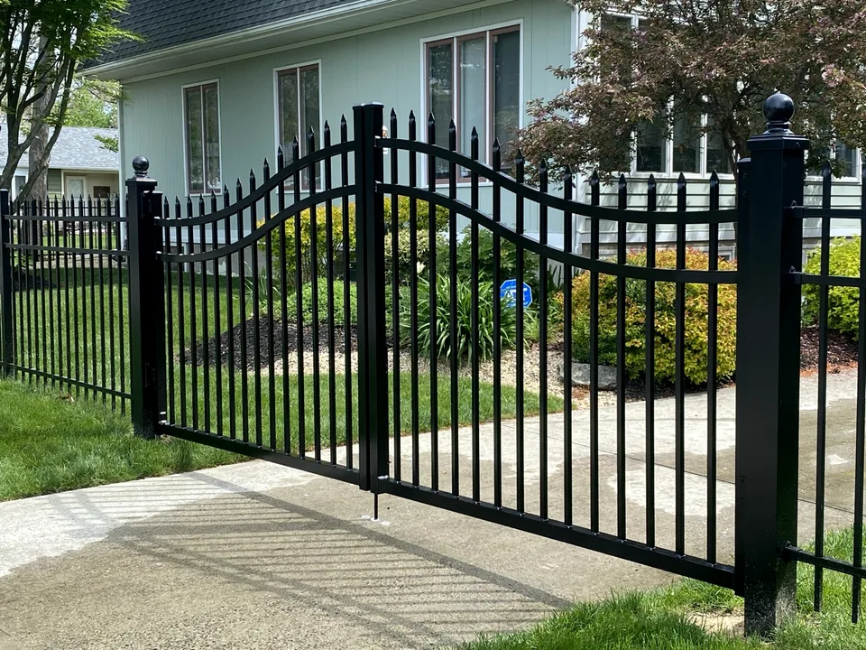Five-foot black aluminum double-drive estate gates with an arched profile at a Mastic Beach, New York residence.