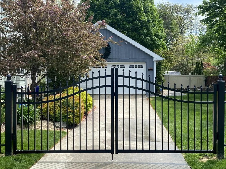 Five-foot black aluminum estate gates creating a decorative residential driveway entrance in Mastic Beach, New York.