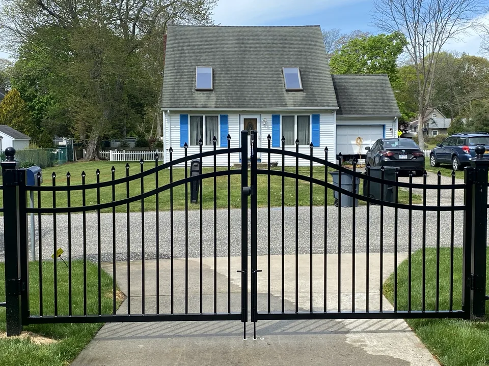 Straight-on view of five-foot black aluminum double-drive estate gates in Mastic Beach, New York.