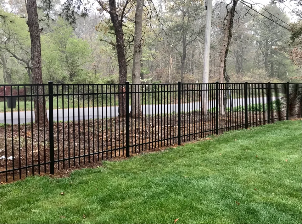 Long run of five-foot black Style 202 aluminum fence in Bellport, New York.