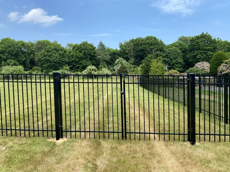 Five-foot black Style 202 aluminum gate and adjoining fence in Center Moriches, New York.