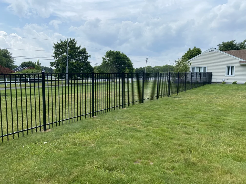 Long run of five-foot black Style 202 aluminum fencing in Center Moriches, New York.