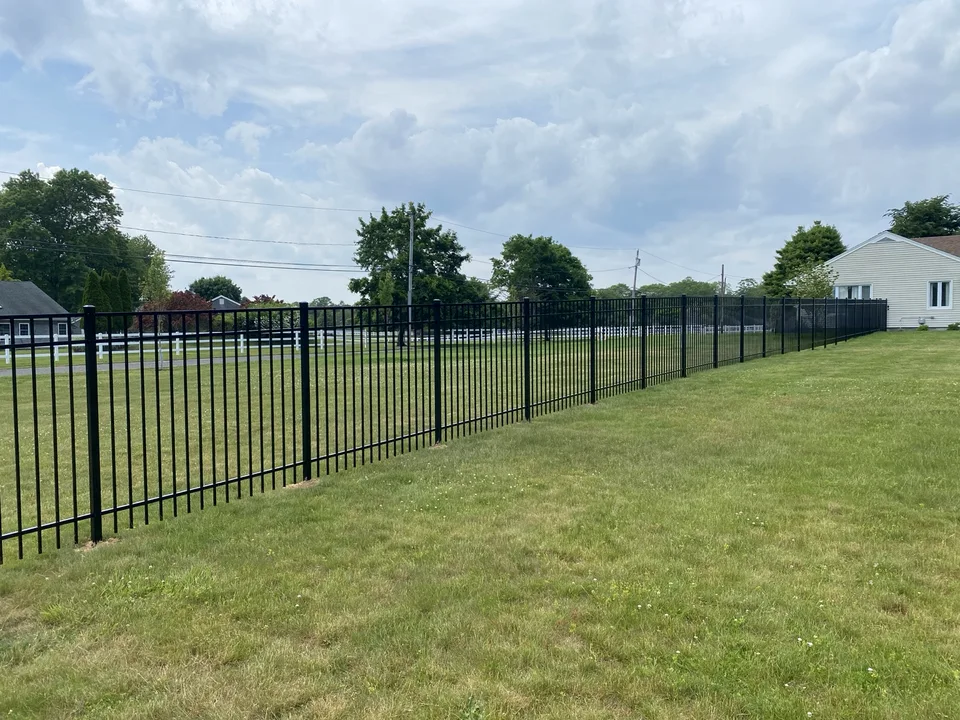 Five-foot black Style 202 aluminum fence defining a residential perimeter in Center Moriches, New York.