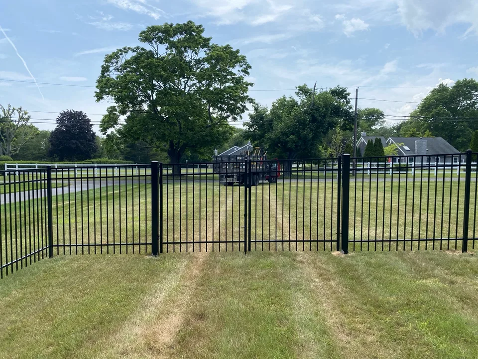 Walk gate within a five-foot black Style 202 aluminum fence in Center Moriches, New York.
