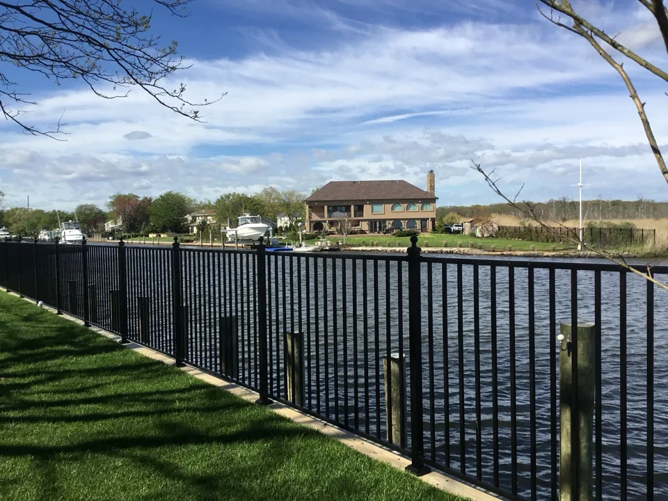 Black aluminum waterfront fence along the canal in East Islip, New York