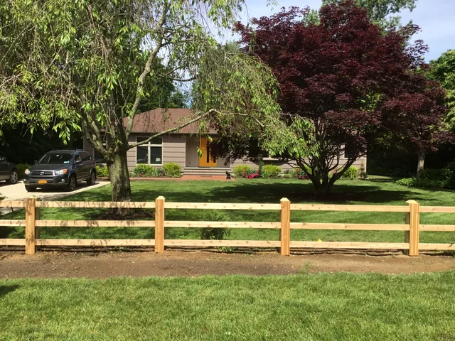 Custom three-rail board fence installation in Bellport, New York