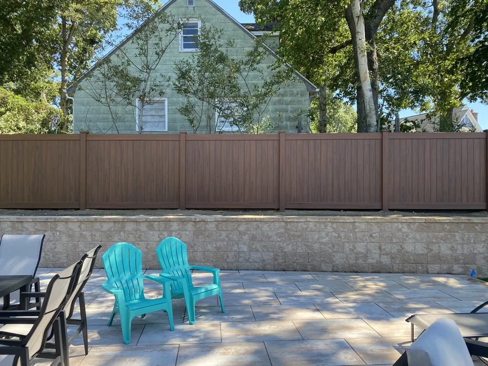 Genuine finished Sag Harbor cedargrain PVC privacy fence viewed from the terrace seating area