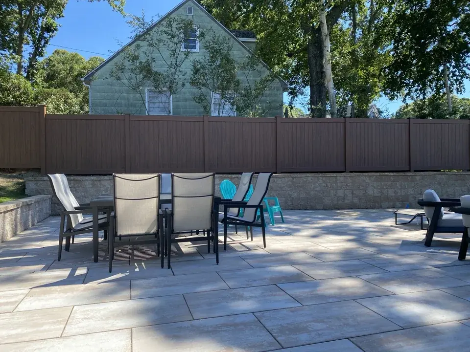 Wide genuine finished view of the cedargrain PVC privacy fence enclosing the Sag Harbor terrace