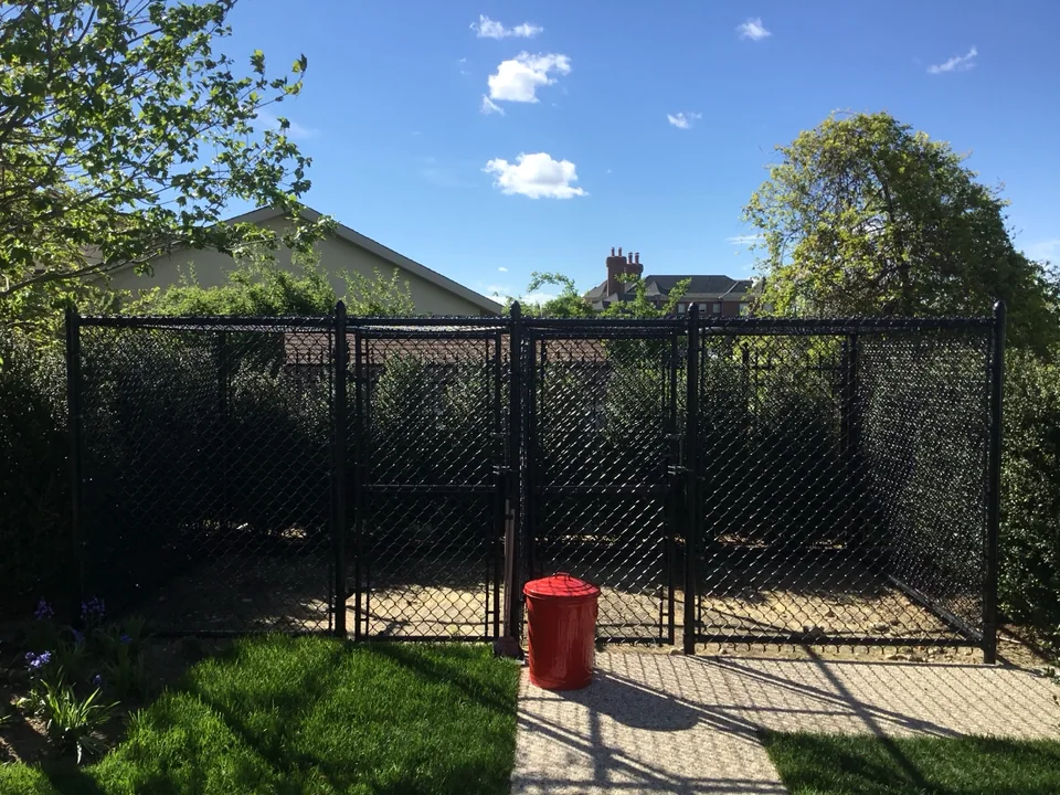 Covered chain link dog enclosure at a residential property in East Islip, New York