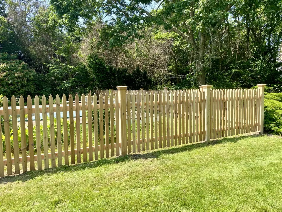 Wide view of the completed cedar picket pool enclosure