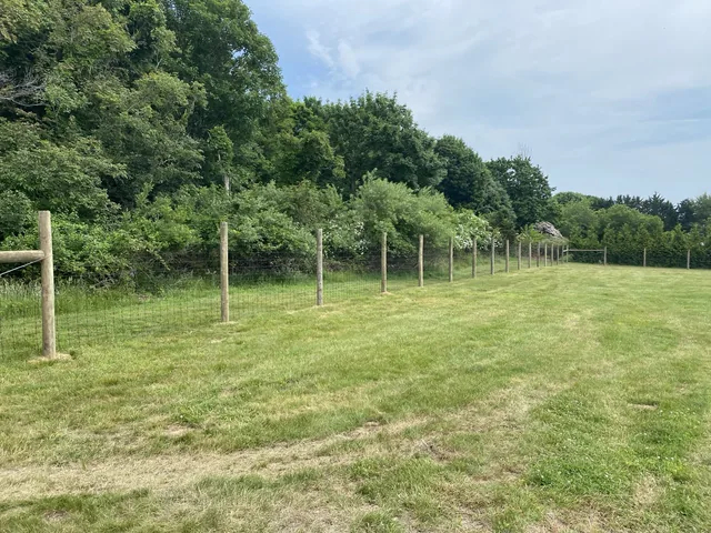 Deer fence with round posts installed in Suffolk County, New York
