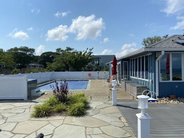 Frameless glass pool fence overlooking a Southold waterfront property