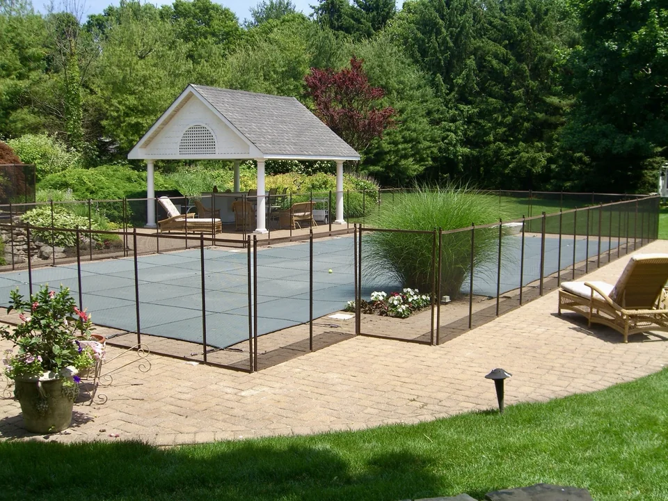 Guardian removable mesh pool fence around a swimming pool in Melville, New York