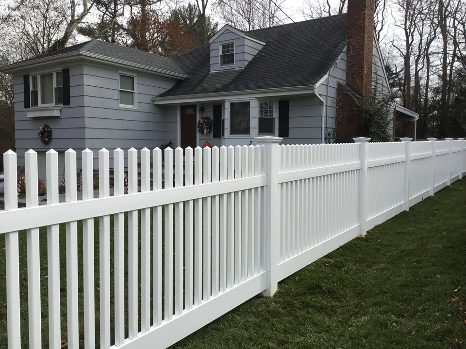 Mixed-height white PVC fence combining Victorian picket and privacy styles in Locust Valley, New York