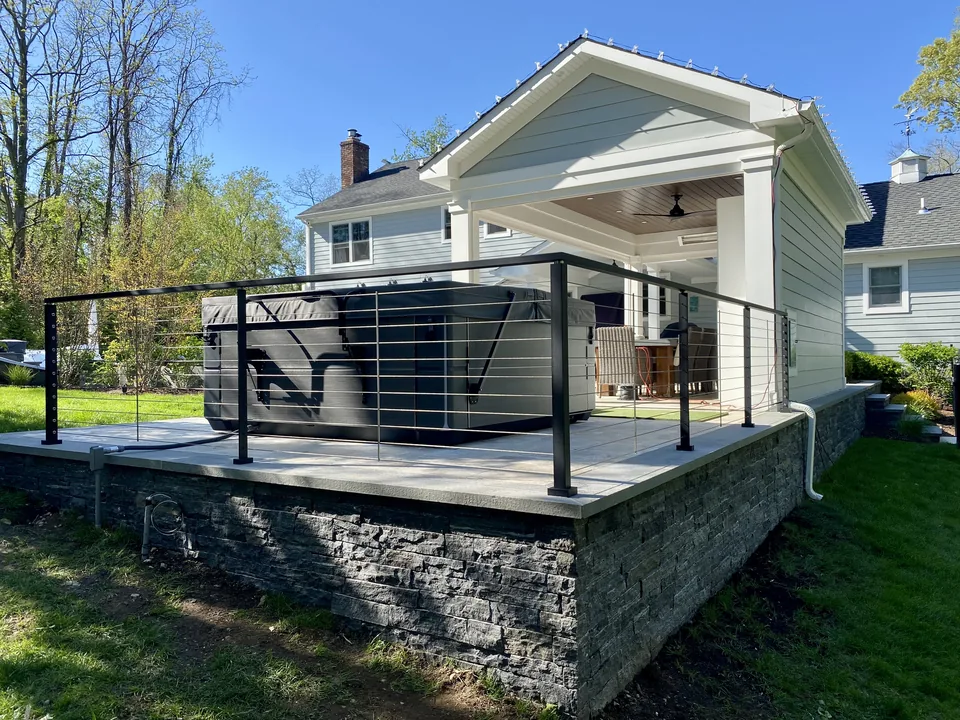 Black aluminum cable railing above a natural stone wall in St. James, New York