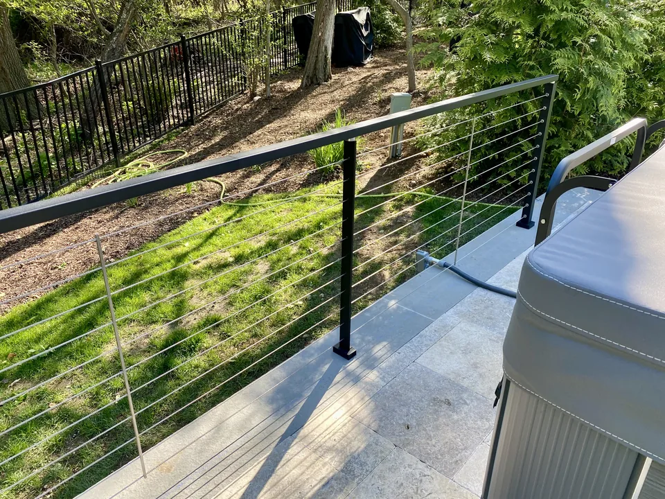 Stainless cable and black aluminum post detail from a St. James railing installation