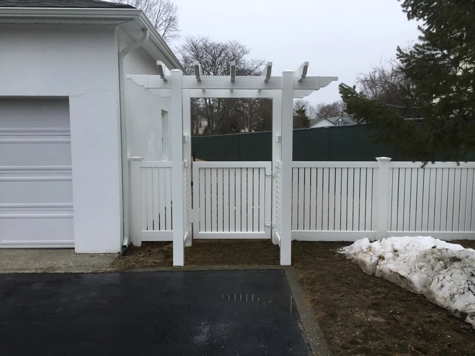 White Interstate Visions New Jersey semi-privacy PVC fence with a decorative arbor walk gate in Patchogue, New York