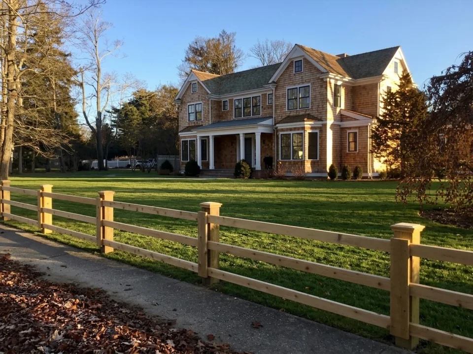 Custom three-rail board fence at a Remsenburg home