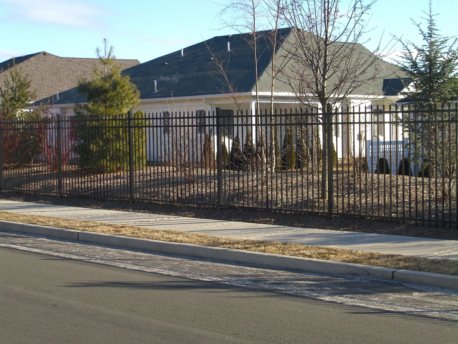 Six-foot black Ultra Aluminum UAS 100 fence along the perimeter of a Stony Brook residential community